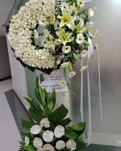 A Radiance Rose white funeral Wreath